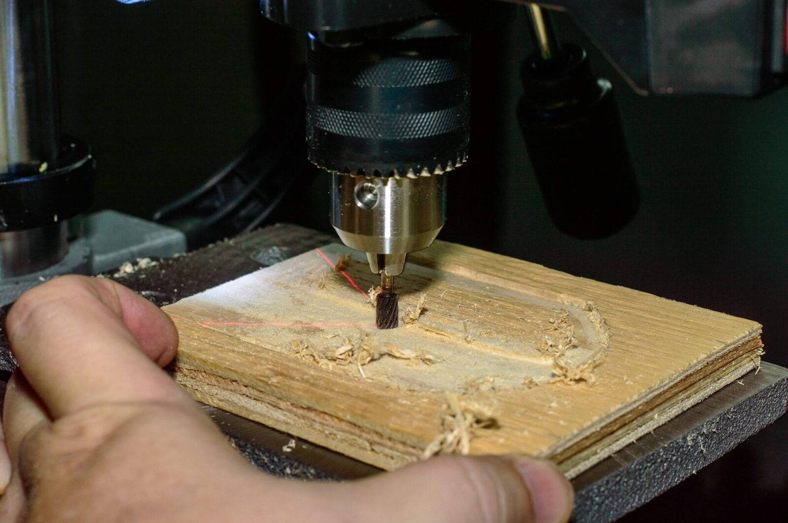A cutter recessing the arched door shape into plywood
