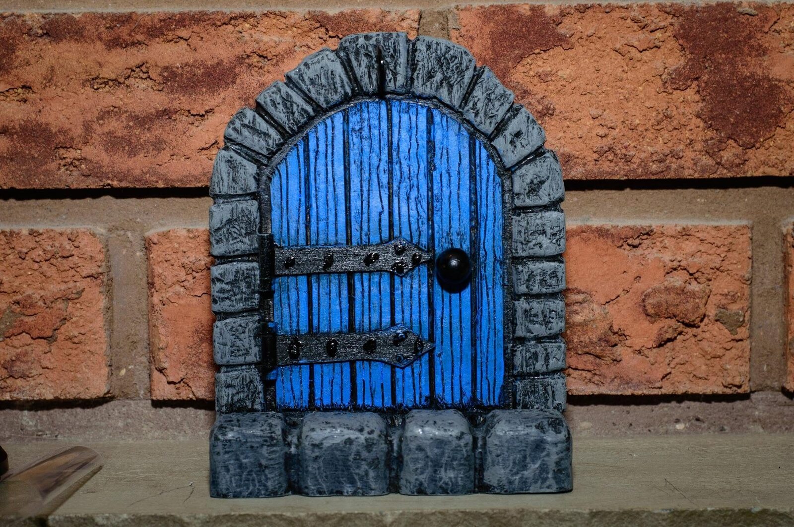 Blue base coat on the door and grey paint on the stone surround